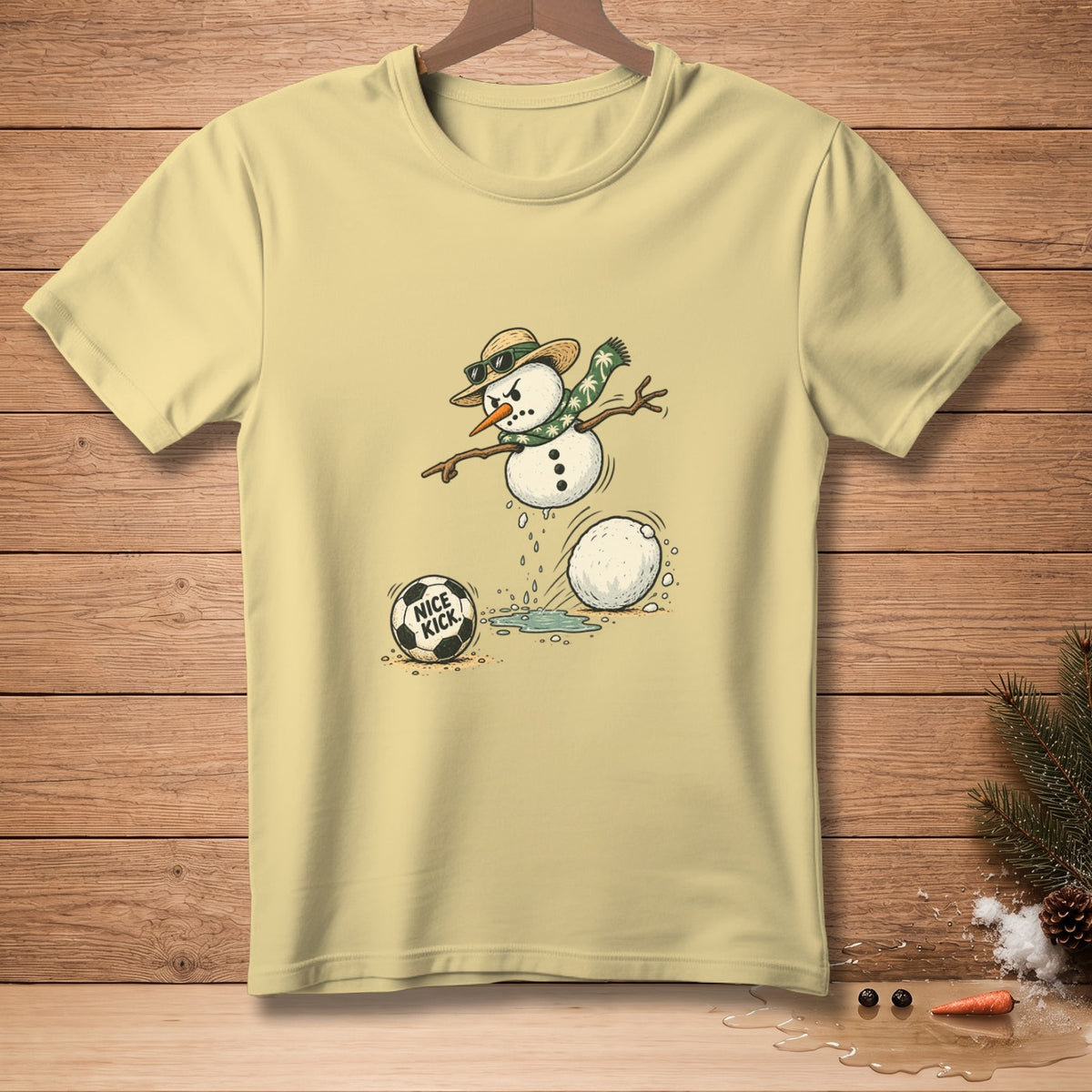 T-shirt with a cartoon snowman playing soccer, featuring text "NICE KICK".