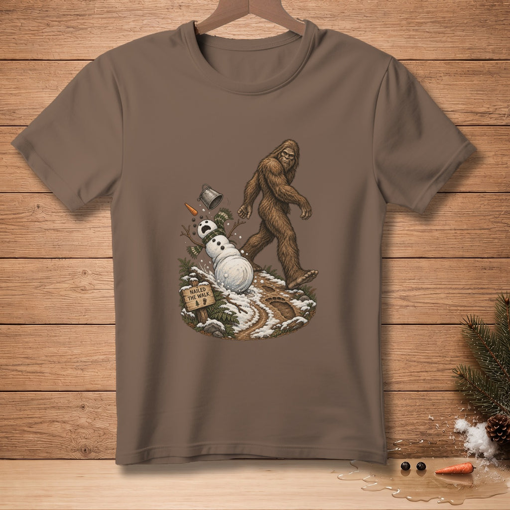 Bigfoot walking past a melting snowman with a sign that reads "Nailed the Walk."