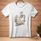 White t-shirt with a drawing of snowmen enjoying a spa day, labeled "Self Care".