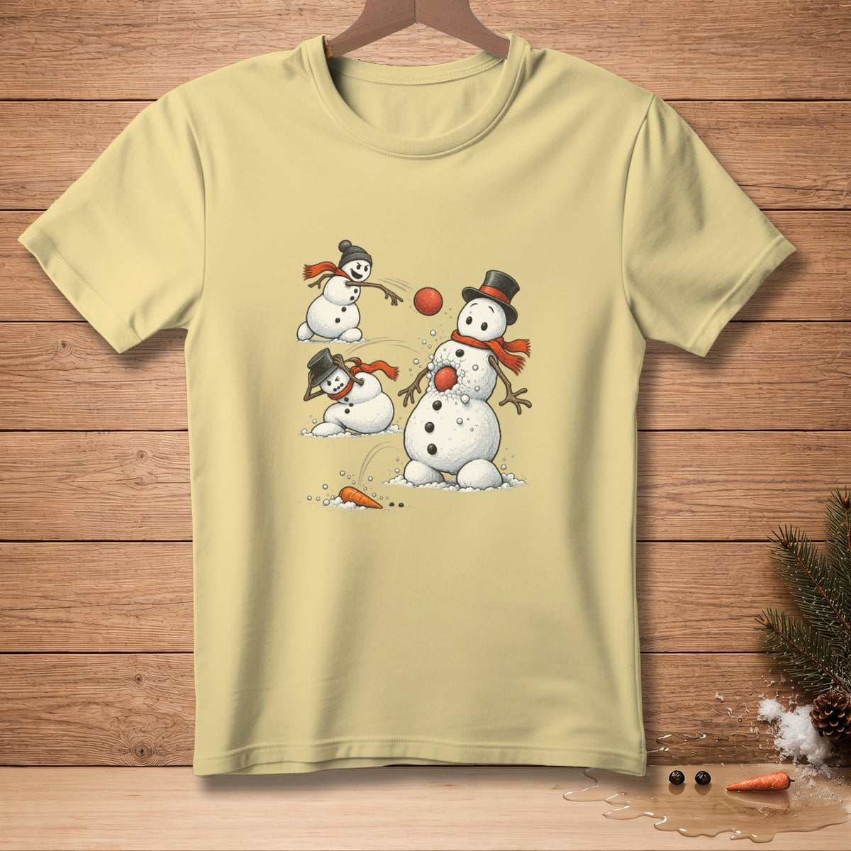 Light yellow t-shirt with cartoon snowmen playing in the snow.