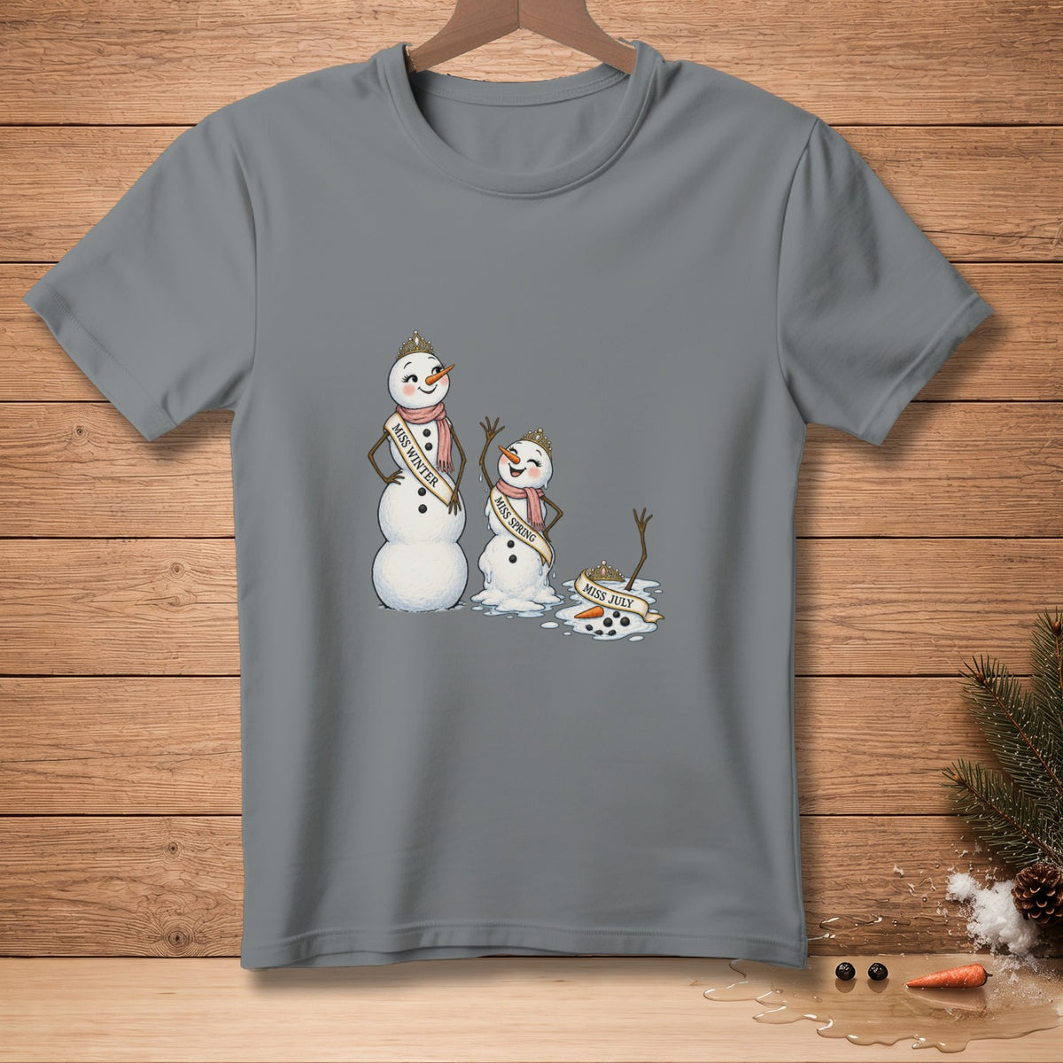 Gray t-shirt with cartoon snowmen: Miss Winter, Miss Spring, and melting Miss July.