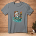 T-shirt graphic of a snowman in a canoe with a parrot and the text "STILL FLOATING".