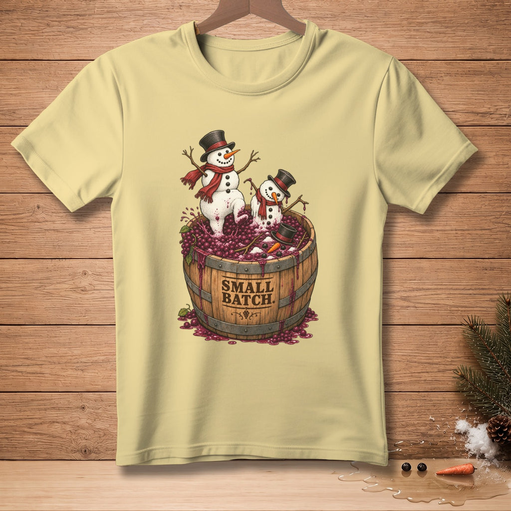 Light yellow t-shirt with cartoon snowmen in a barrel of grapes, reading "Small Batch".