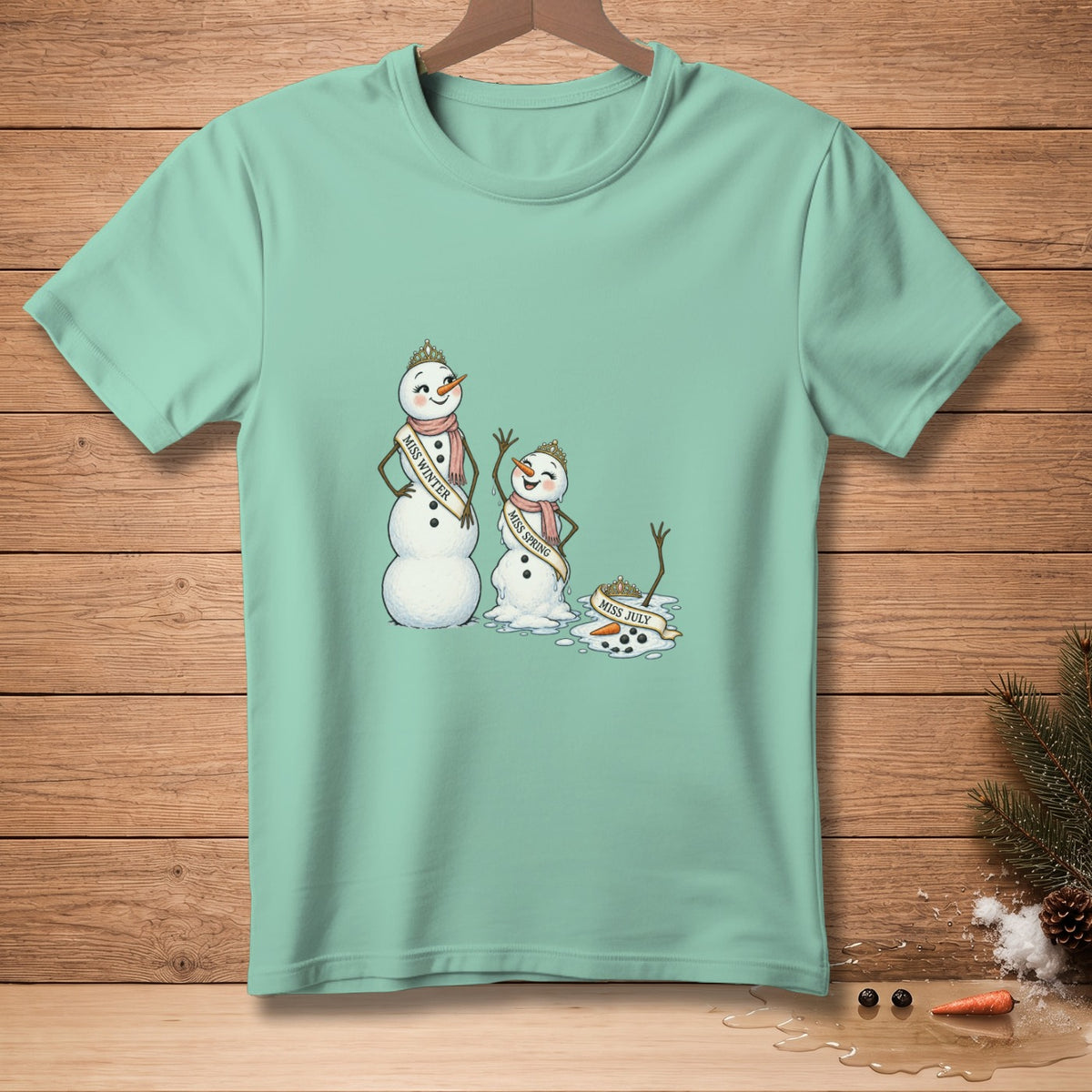 T-shirt with melting snowmen labeled "Miss Winter," "Miss Spring," and "Miss July."