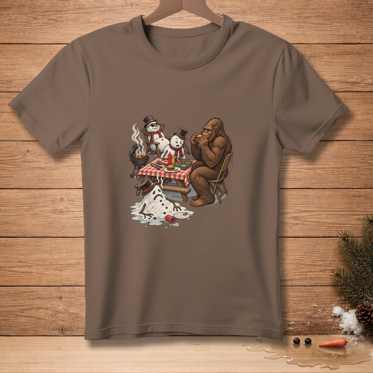 Bigfoot eating a burger with melting snowmen at a picnic table.