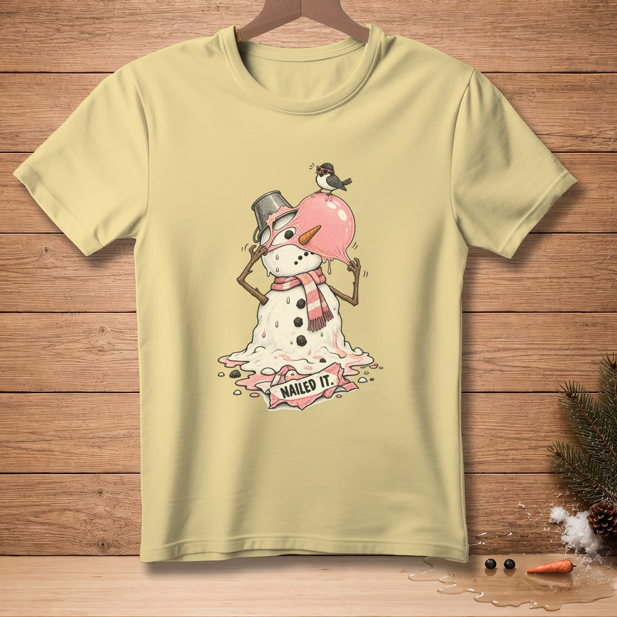 Yellow t-shirt with melting snowman graphic and the text "NAILED IT."