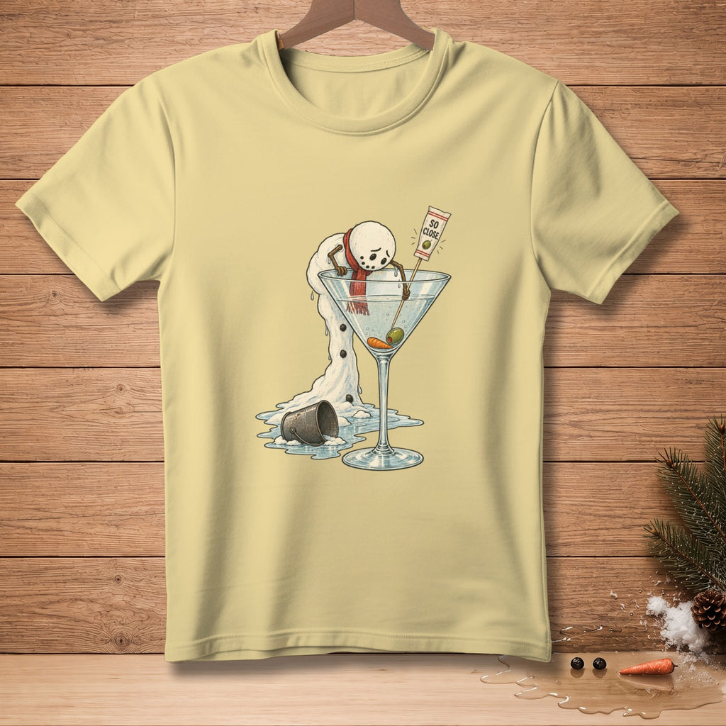 Melting snowman with red scarf reaches for martini glass with olives and text "So Close."
