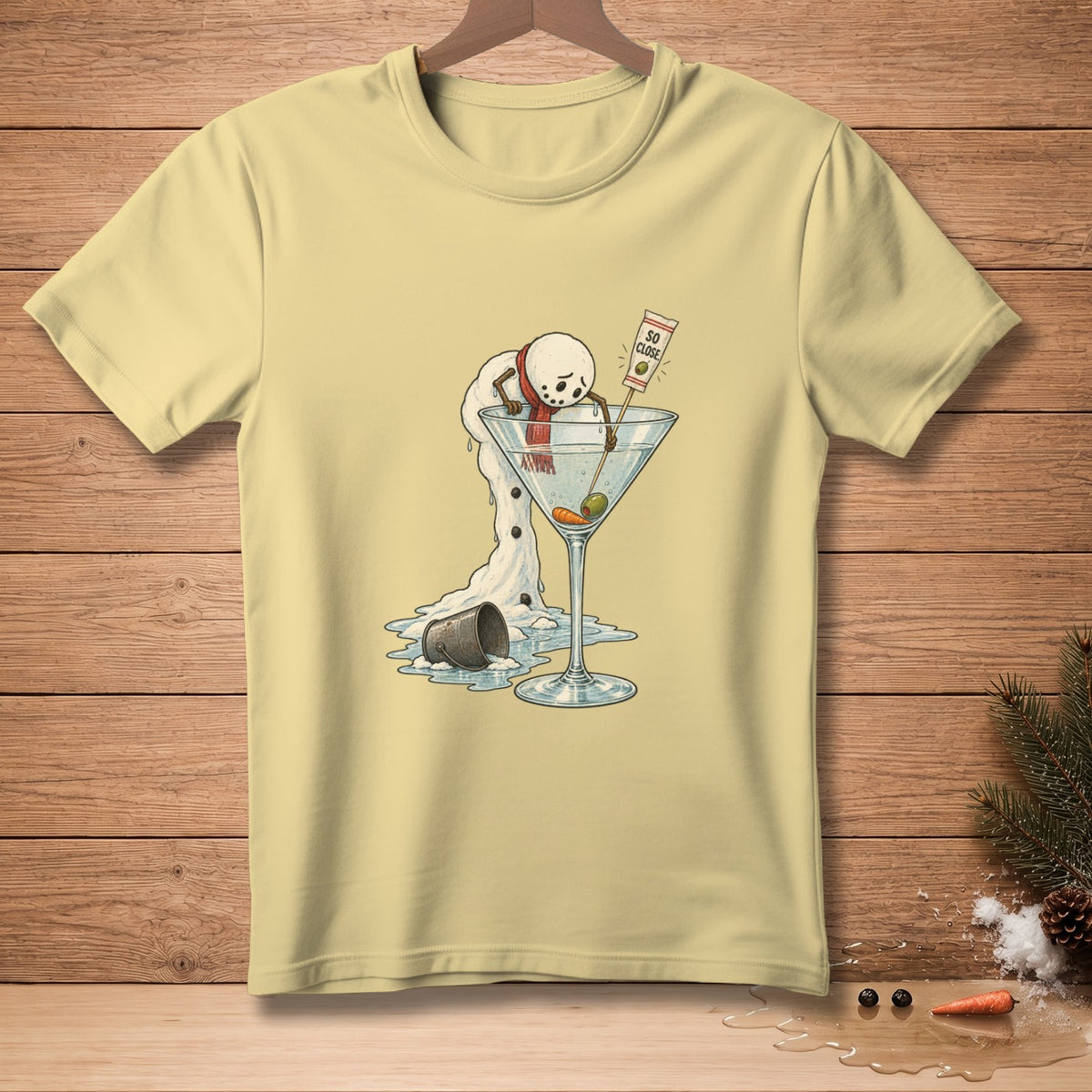 Melting snowman with red scarf reaches for martini glass with olives and text "So Close."