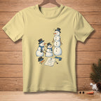 Yellow t-shirt with a drawing of three snowmen and a sketch of a snowman.