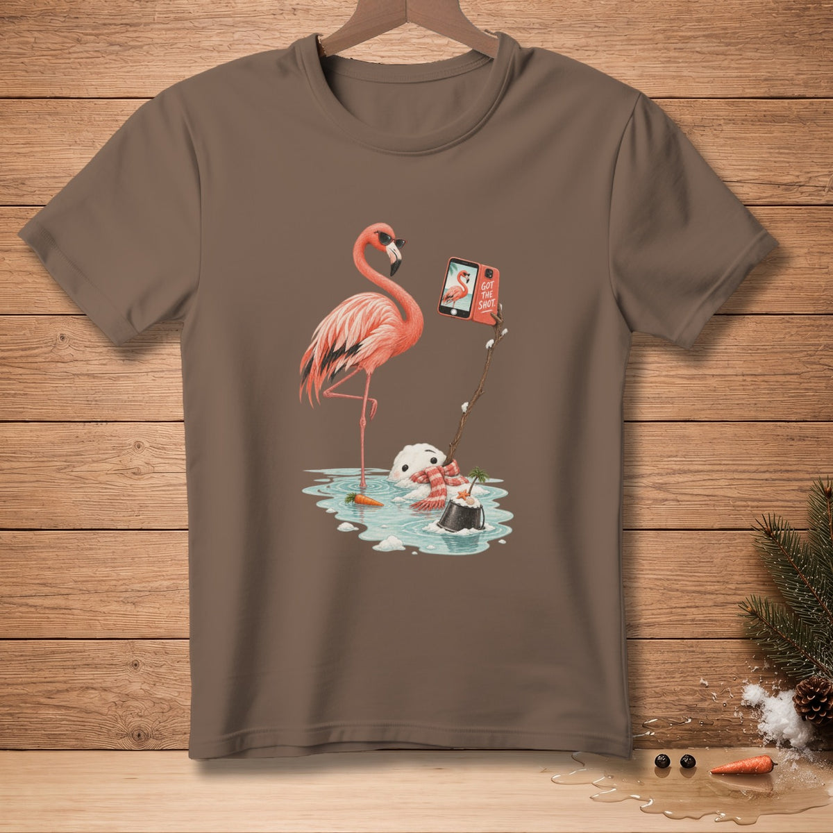 Flamingo taking a selfie with a melting snowman on a brown t-shirt.